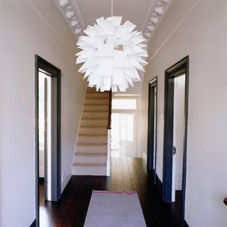 hallway with white wall and stairway