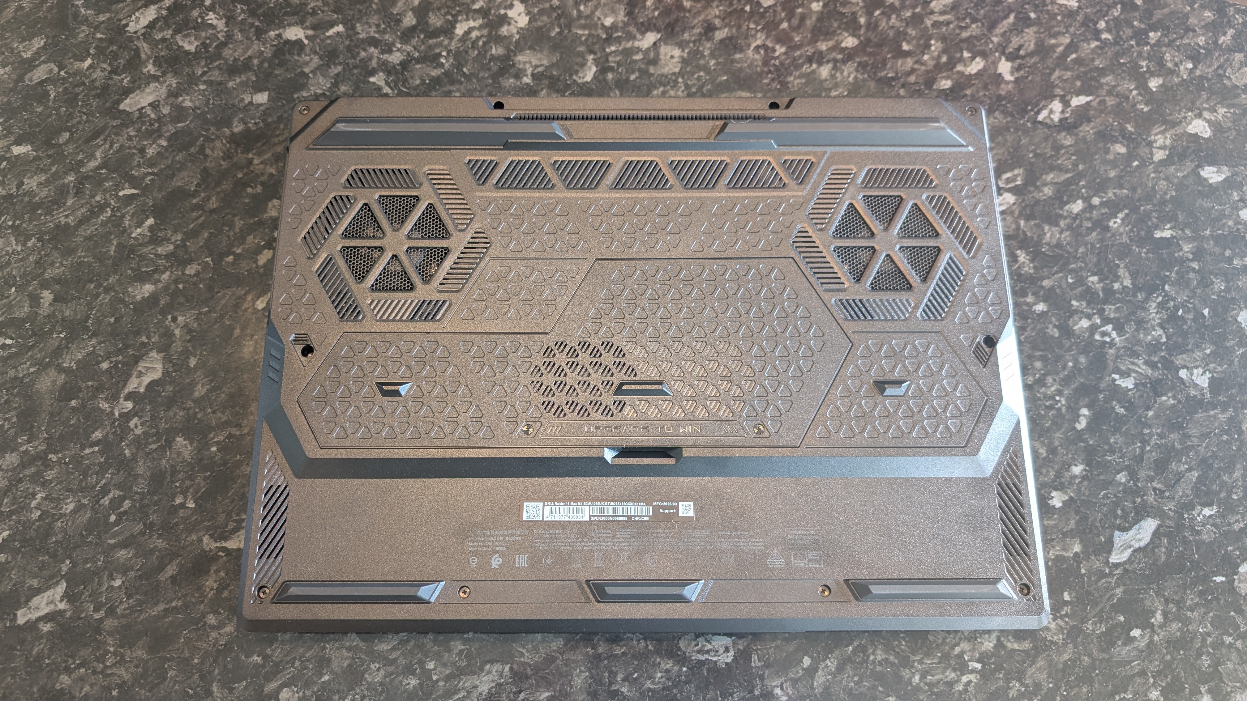 The MSI Raider 16 Max HX gaming laptop pictured on a black marble worktop.