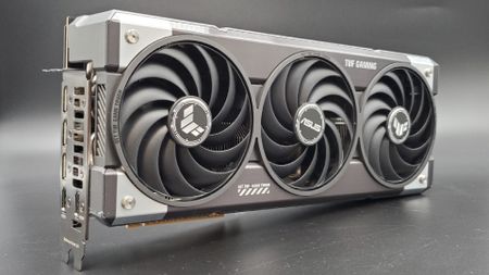The Asus TUF Gaming RTX 5070 Ti OC Edition in 3/4 profile on a silver background