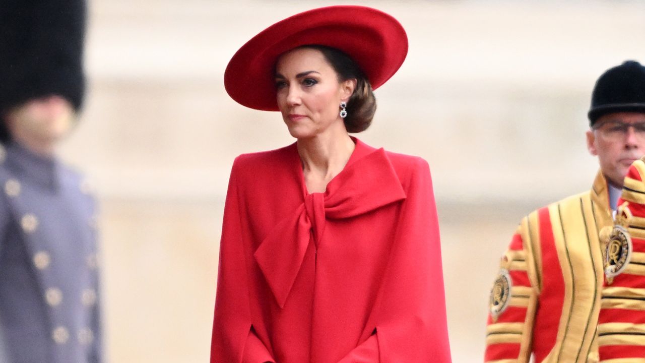 Kate Middleton in a red bow cape coat.