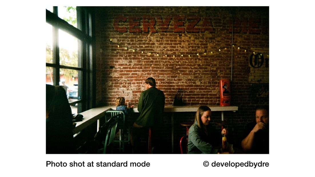 Reto Pano sample image of people in cafe against brick wall