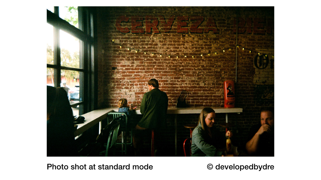 Reto Pano sample image of people in cafe against brick wall