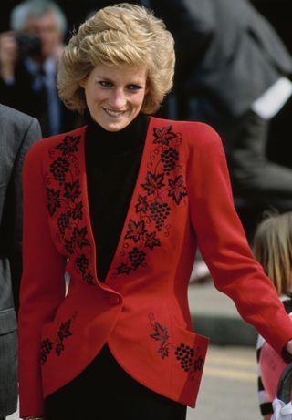 Diana, Princess of Wales wearing a red jacket embroidered with black leaves, at the launch of the 'Bike 89' charity event in Hyde Park