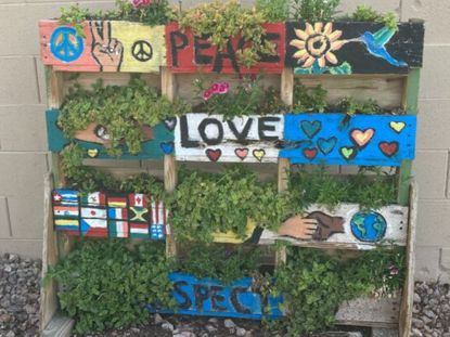 Vertical garden boxes painted with encouraging images