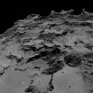 A wide terrace is seen in the foreground of this image of the Seth region of Comet 67P/Churyumov-Gerasimenko. A deep pit reveals the layers of the comet, while the irregular and fractured morphology of the comet is also shown.