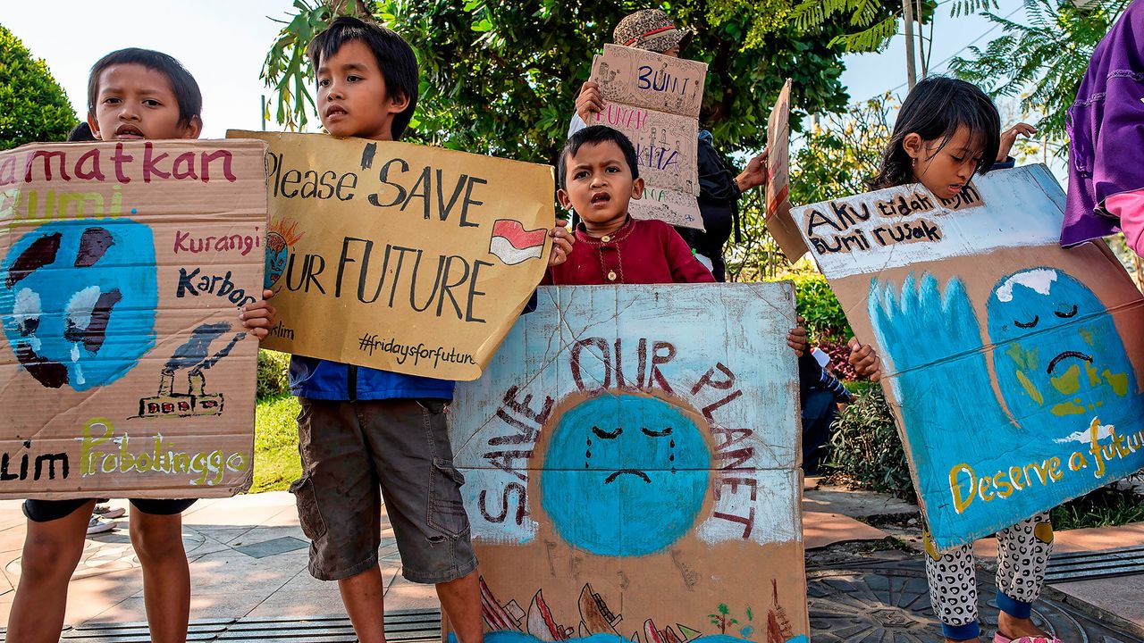 A group of Indonesian children hold placards as they take part in a global climate change campaign in Surabaya.