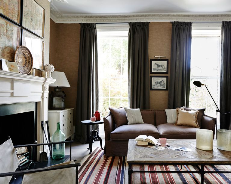 neutral living room with textured wallpaper and brown curtains