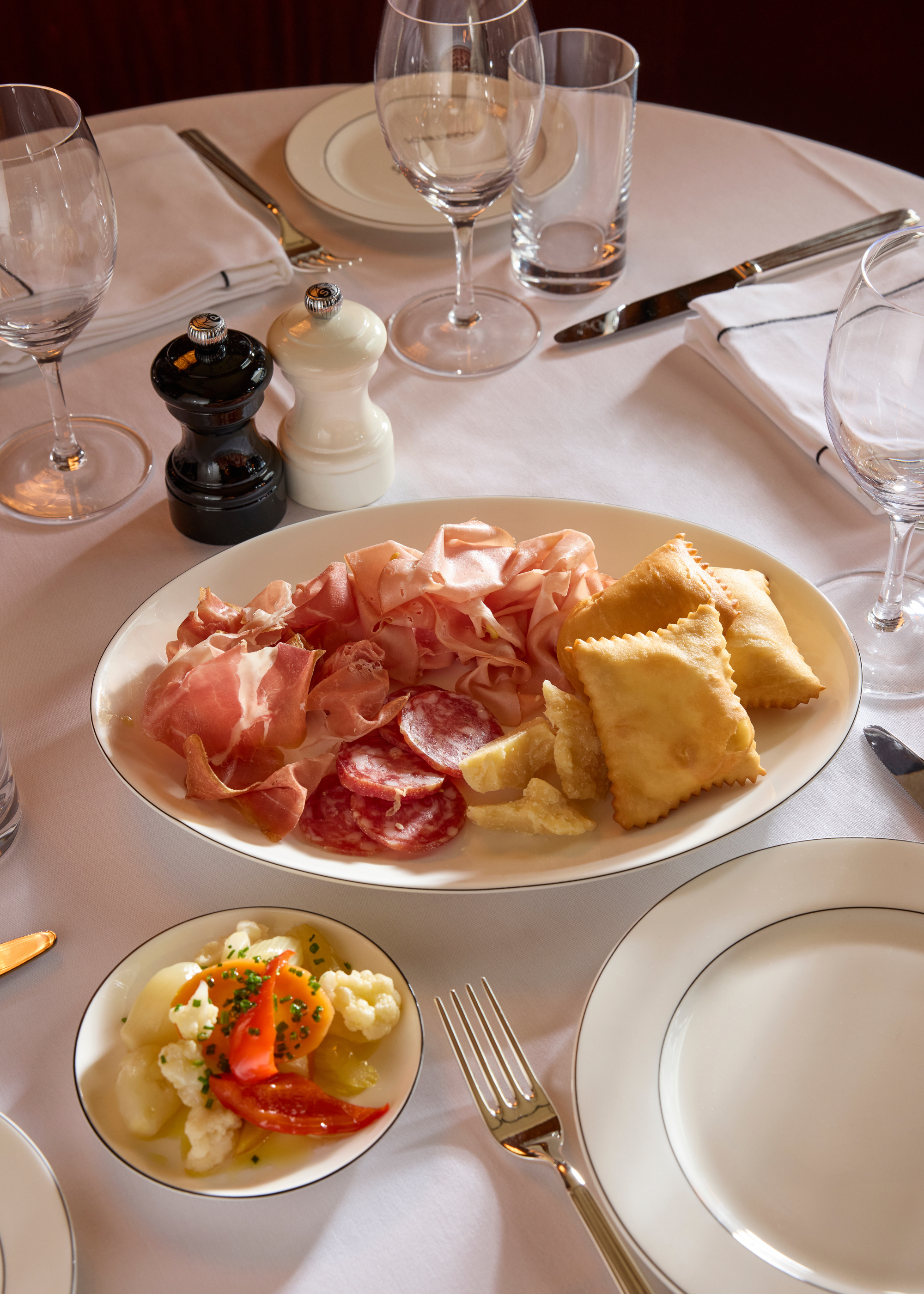 gnoccho fritto platter on a white tablecloth covered table
