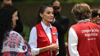 Queen Letizia talks with members of the Spanish Cooperative as she visits the Bicentennial Square