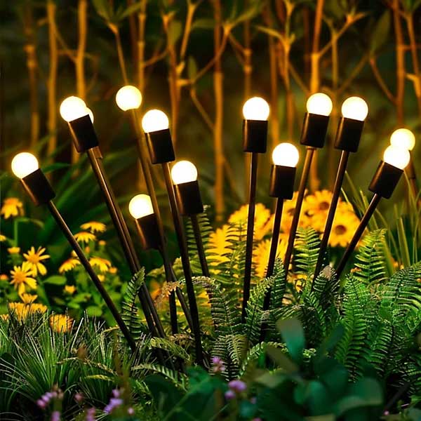 set of stake solar lights inserted into a flowerbed