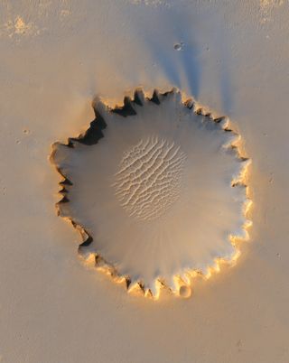 Sand blown by wind into ripples within Victoria Crater at Meridiani Planum on Mars, as photographed by NASA’s Mars Reconnaissance Orbiter on October 3, 2006.