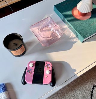 Table with game controller and candle