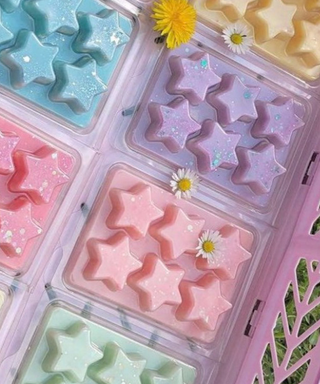 A pastel crate full of colorful, pastel star-shaped wax melts