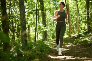 Lily Aldridge taking a jog in the woods.