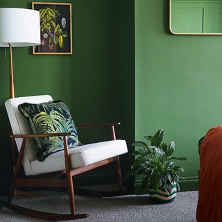 green living room with rocking chair and floor lamp