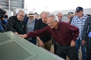 EECOM (Electrical, Environmental and Consumables Manager) Bill Moon joins other Apollo-era flight controllers checking out the newly restored Mission Control consoles on Nov. 8, 2018.