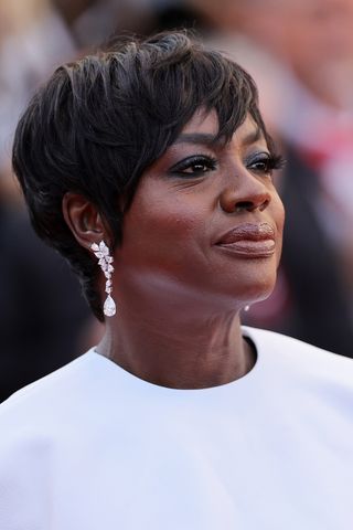 Viola Davis is pictured with a dark brunette pixie cut during the Red Carpet of the closing ceremony at the 77th annual Cannes Film Festival at Palais des Festivals on May 25, 2024 in Cannes, France.