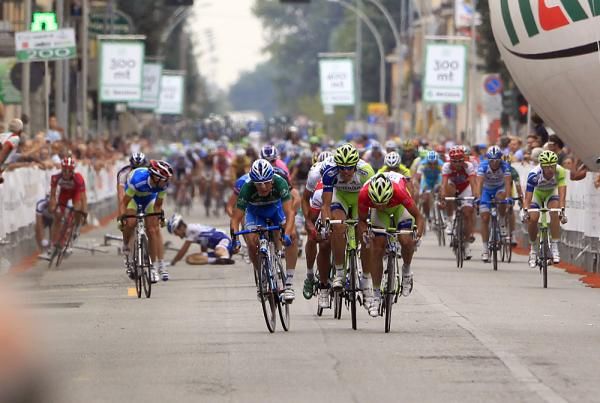 The sprinters barrel to the line as behind, a crash takes out one rider.