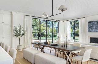 white living room and dining room combo with white curtains and glass doors