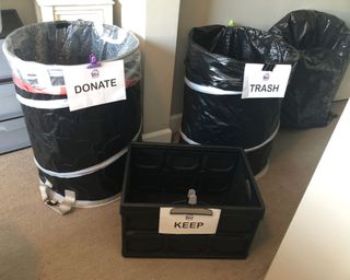 Three-bins-lined with black trash bags and labeled donate-trash-keep