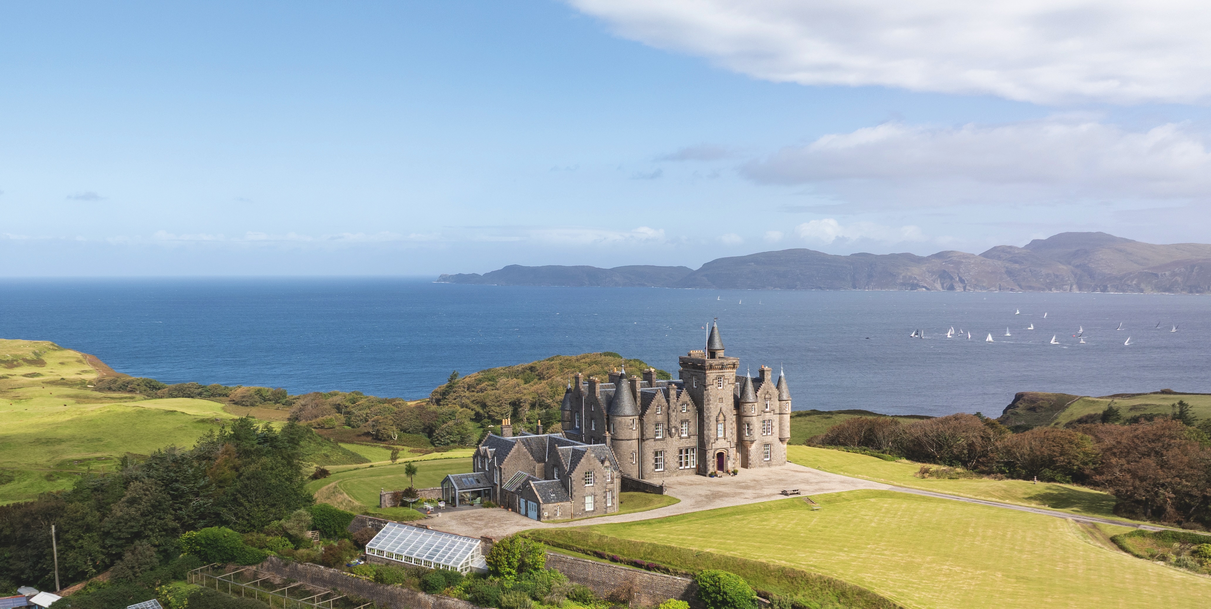 A view of Glengorm castle, with the sea behind