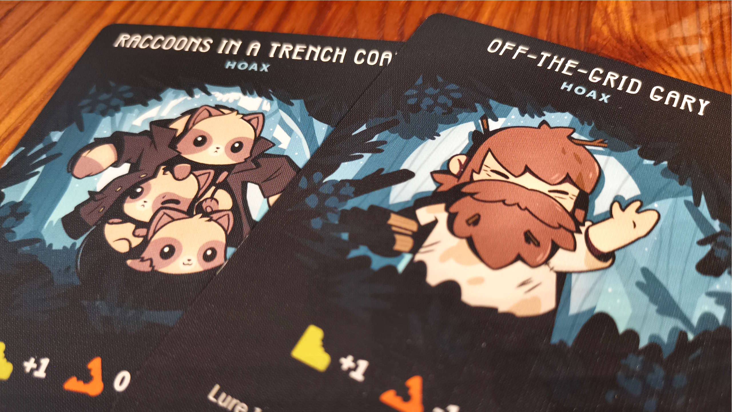 Twisted Cryptids cards on a wooden surface