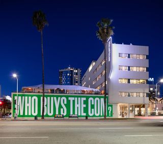 Barbara Kruger's 'Who Buys The Con' installation on NeueHouse Hollywood façade during Frieze LA
