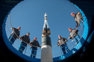 The Expedition 58 crew and backup crew checked out a model of their Soyuz ride before launch at Baikonur Cosmodrome in Kazakhstan.