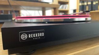 Rekkord Audio F110 turntable front view showing logo and pink record