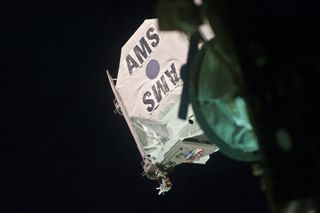 An image shows the AMS attached to the outside of the ISS.