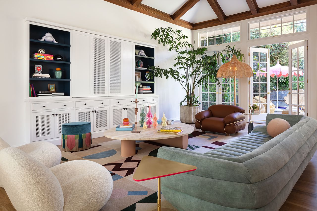 living room with blue rounded sofa and triangular accent table