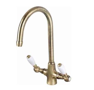 brass mixer tap with white lever handles