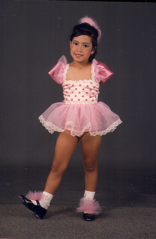 A young Jessica Cox in a pink ballet outfit.