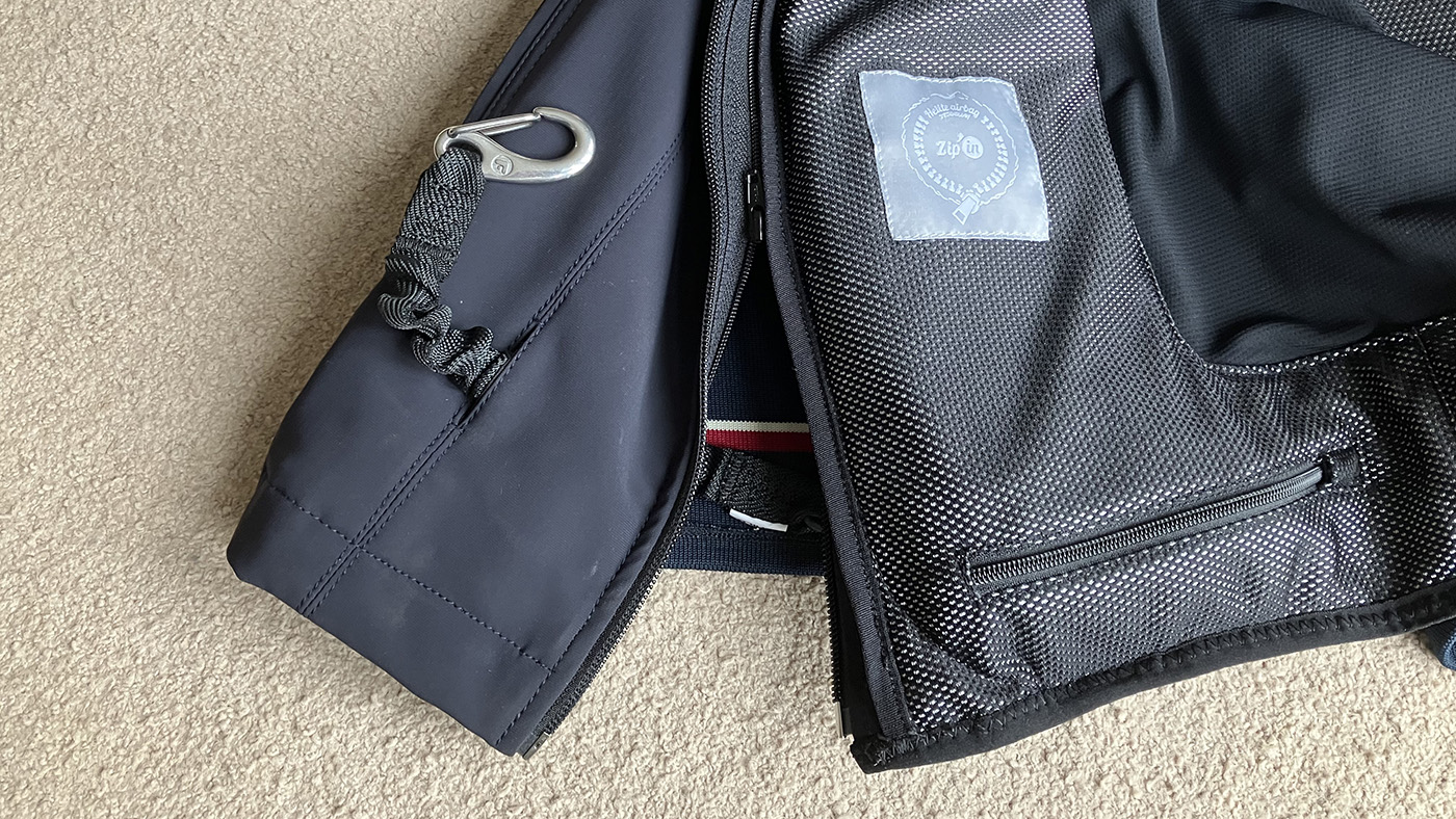 Showing how the Helite Zip&amp;rsquo;In 2 Airvest zips inside the Helite Airshell Prestige Outer, with the lanyard passing through the discrete opening to the outside of the gilet.