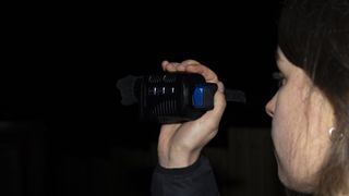 A female holding the Rexing B1 Basic night vision monocular