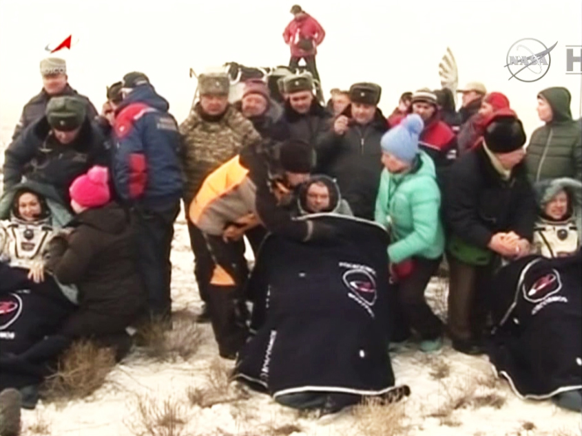 Russian cosmonauts Elena Serova (left), Alexander Samokutyaev (center) and NASA astronaut Barry Wilmore are recline in blanket-covered chairs after landing on Earth on March 11, 2015 EDT (March 12 local time) on the steppes of Kazakhstan. The trio spent 1