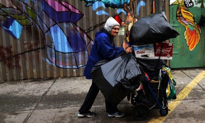 A woman who makes a living gathering bottles and cans pushes her evening&amp;#039;s collection in New York City on Feb. 16.