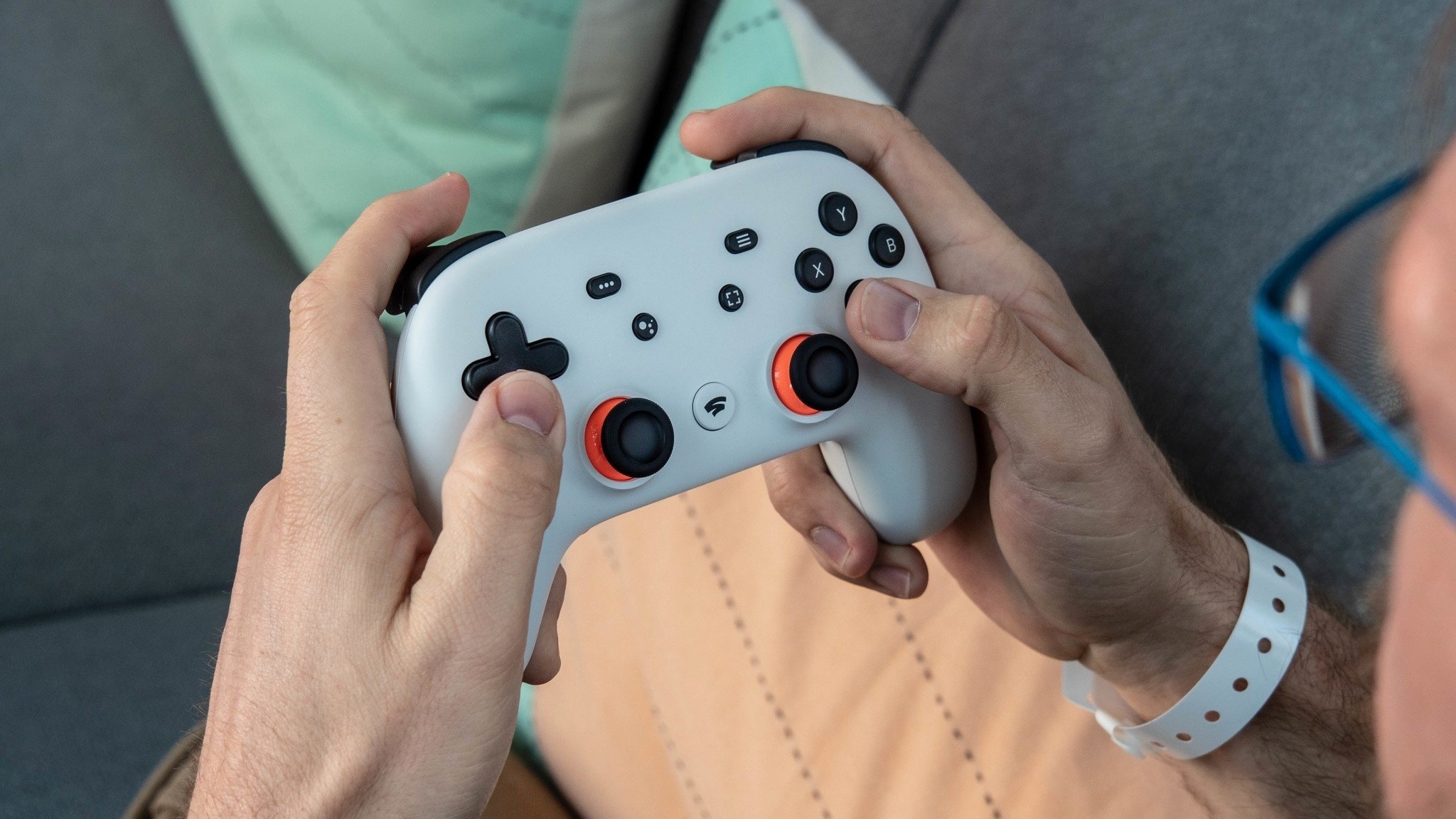 Close-up of the Stadia Controller held in Russell Holly's hands.
