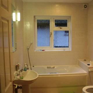 bathroom with vanity unit and bathtub