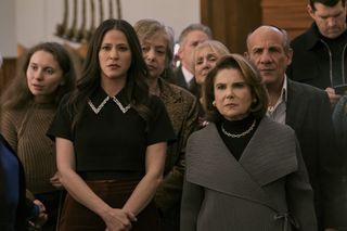 Jackie Tohn as Esther and Tovah Feldshuh as Bina, standing among congregants in a synagogue, in episode 101 of Nobody Wants This.