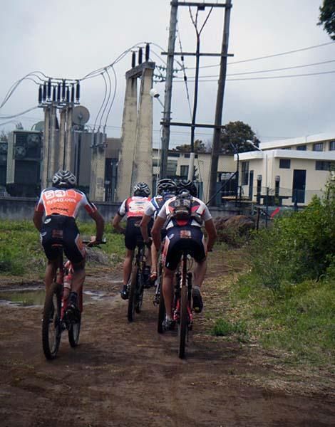 A group of four riders powers along.