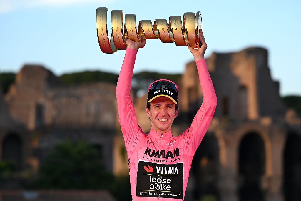 ROME, ITALY - JUNE 01: Simon Yates of Great Britain and Team Visma | Lease a Bike celebrates at podium as Pink Leader Jersey winner with the Trofeo Senza Fine during the 108th Giro d&amp;amp;apos;Italia 2025, Stage 21 a 144.8km stage from Rome to Rome / #UCIWT / on June 01, 2025 in Rome, Italy. (Photo by Dario Belingheri/Getty Images)