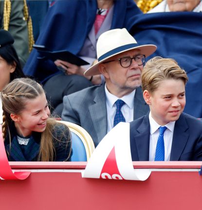 Prince George, Princess Charlotte and Prince Louis sitting in a row at the VE Day 80th anniversary parade