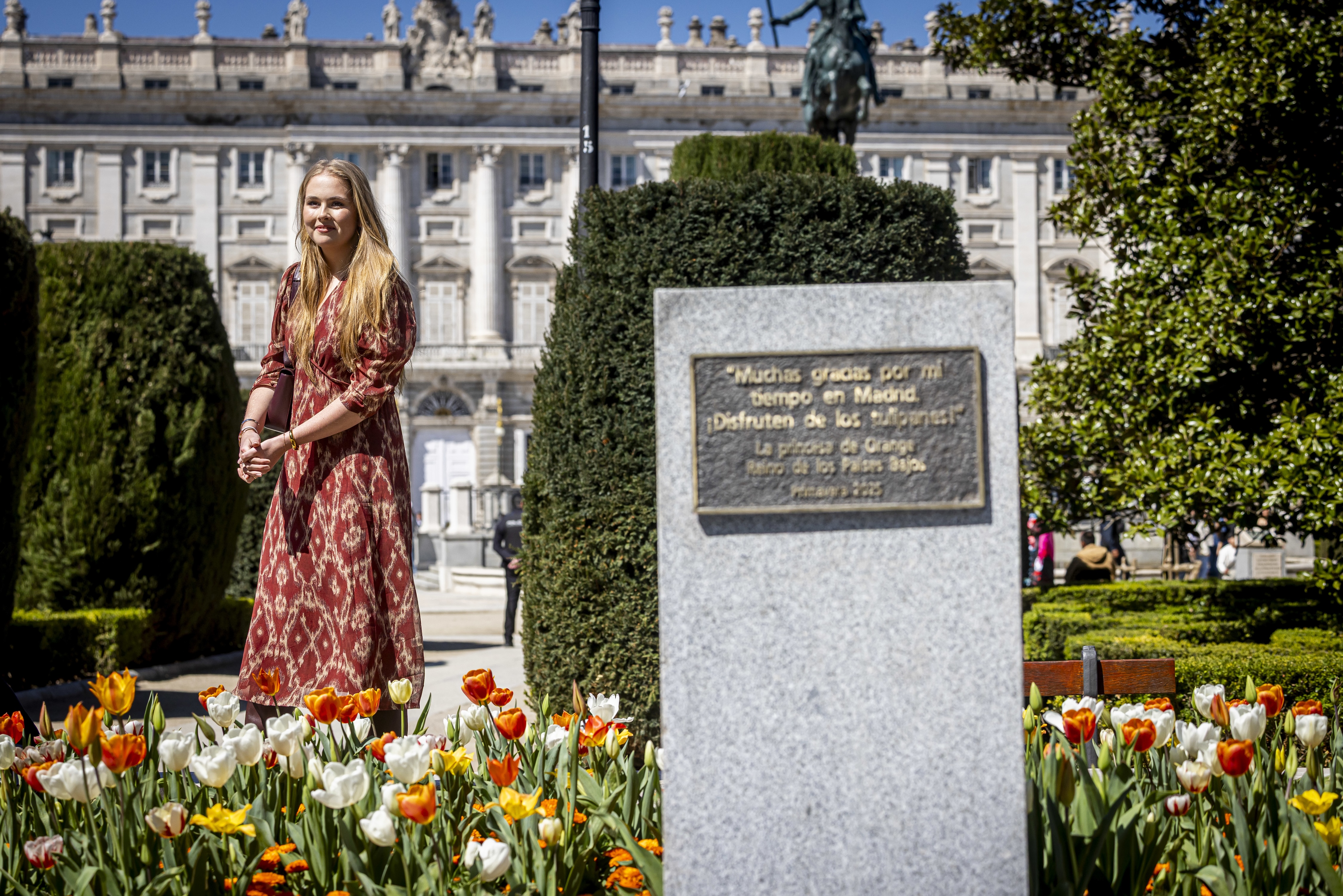 Princess Catharina-Amalia wearing a red dress in a tulip garden in Madrid, Spain