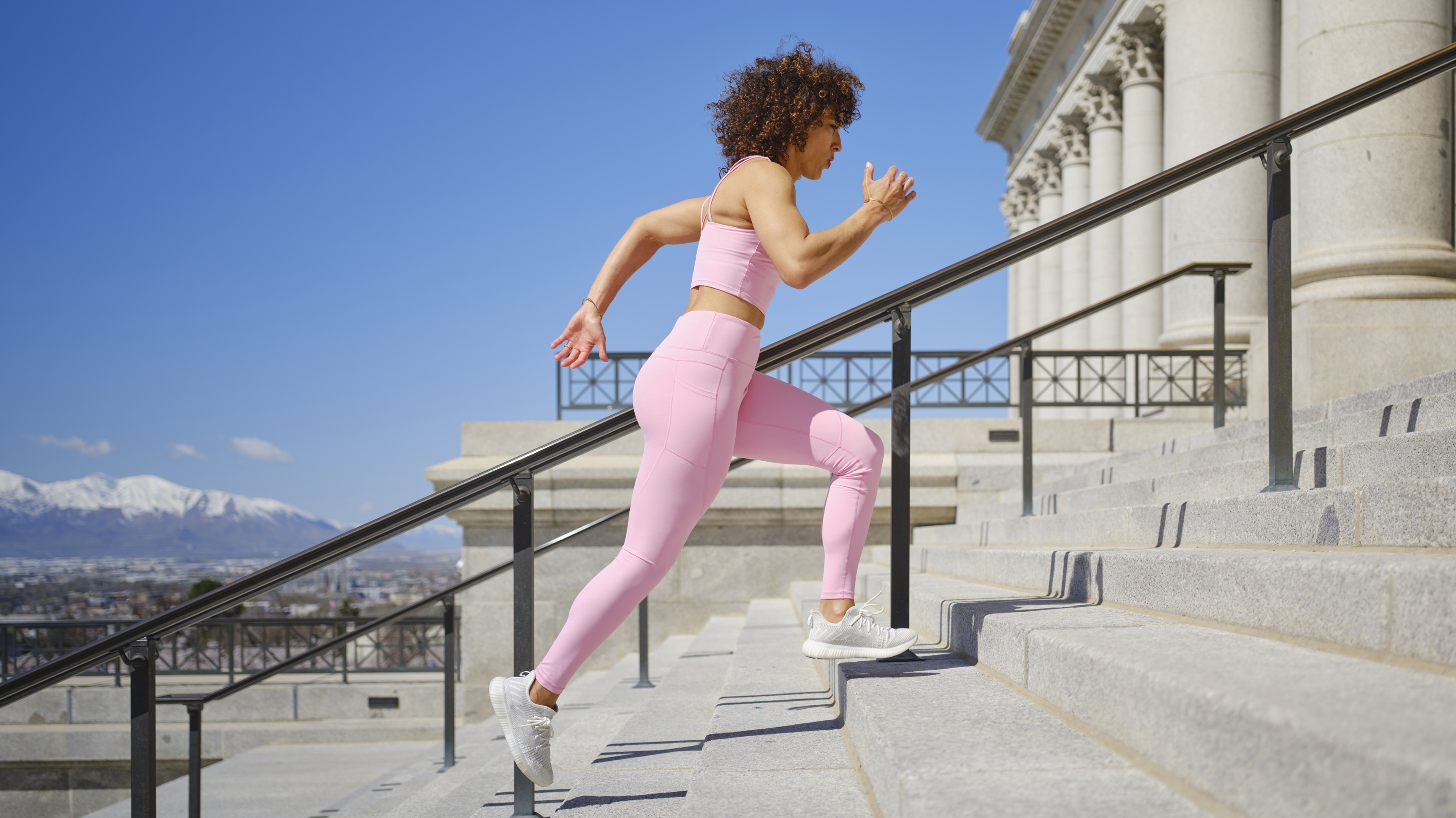 A woman runs up some steps at a government building.