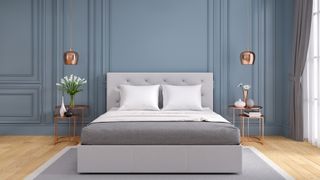 How to optimize your bedroom for sleep: A stylish bedroom for sleep decorated with blue walls to promote calm 