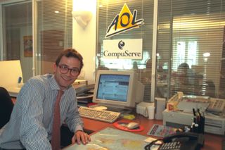 President of AOL and CompuServe France, Trepporz poses in front of 1990s computer