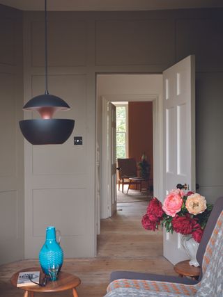 A living area with greige walls and wooden flooring