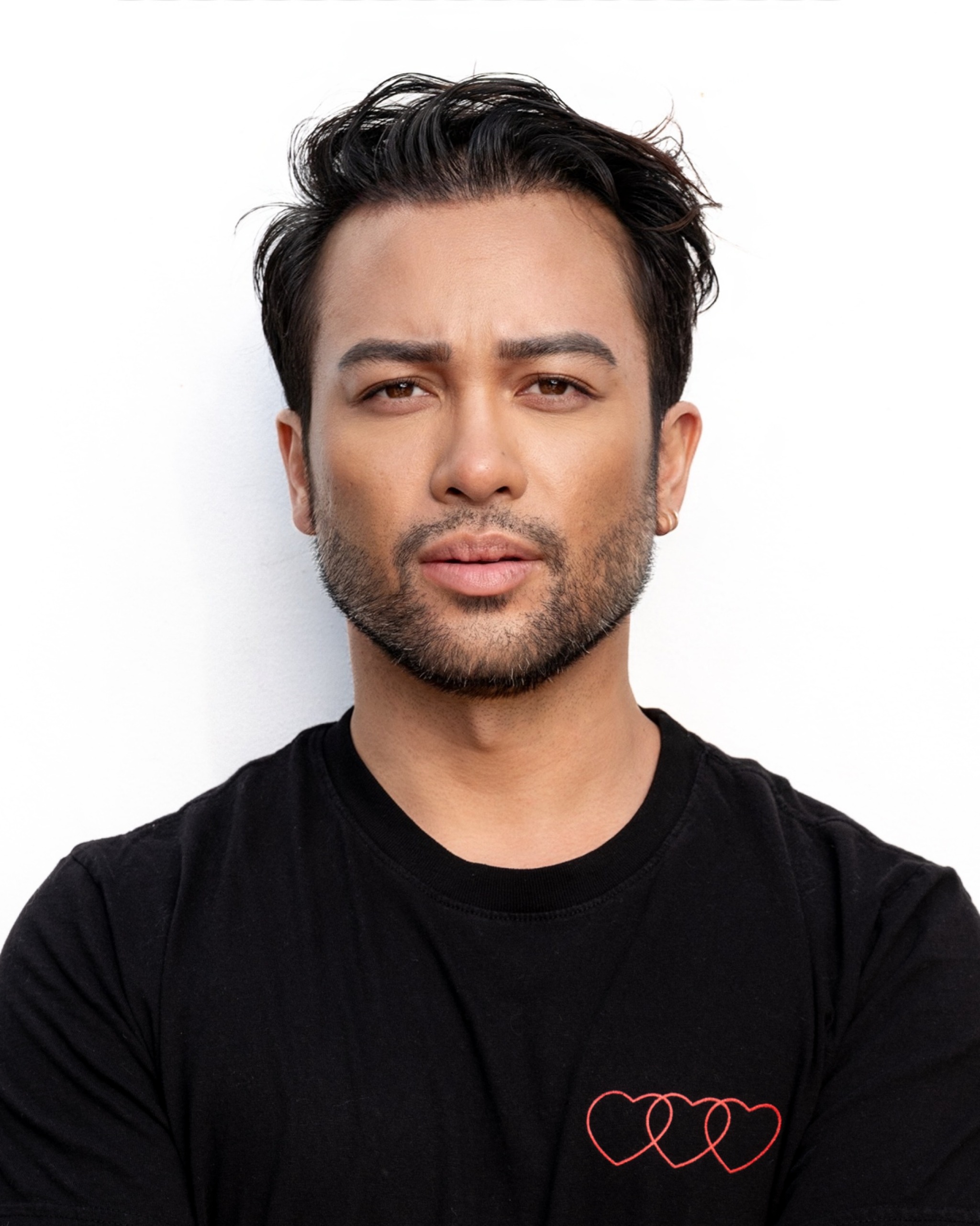 an asian man in a black t-shirt with dark hair and a beard