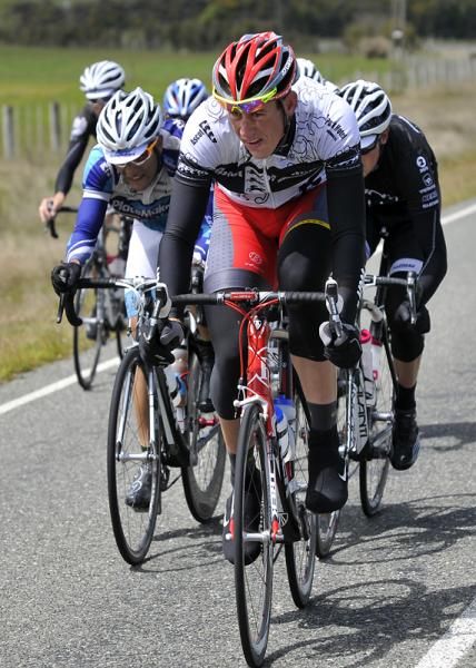 The peloton has splintered into many small groups after the Blackmount Hill, this group led by Clinton Avery